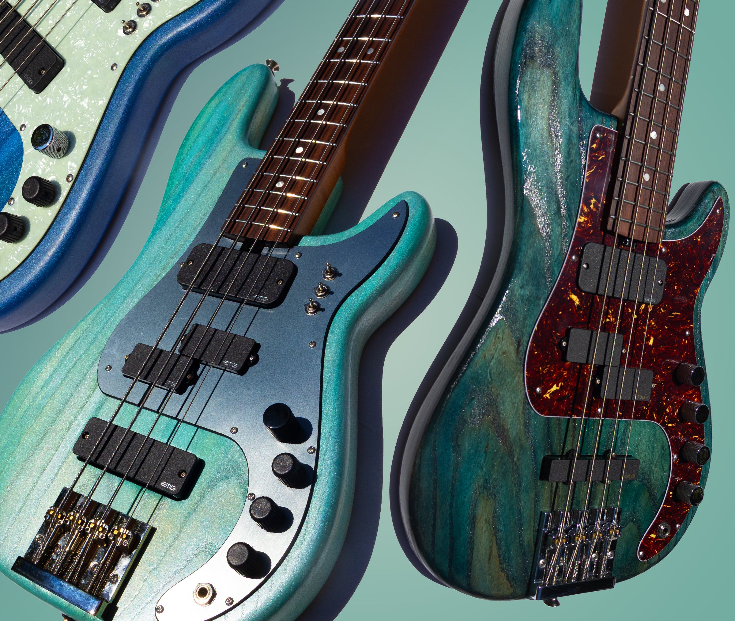 Two electric bass guitars with a gradient blue background